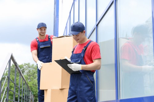 Man with van removal service loading furniture in Perivale