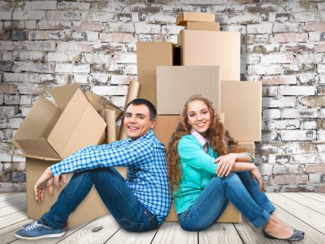 Workers handling furniture with care during loading