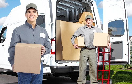 Man with a van loading household items for a move in Perivale