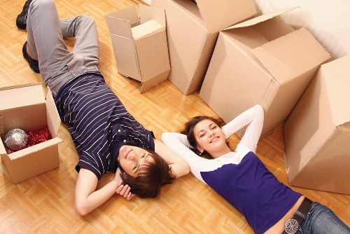 Professional moving team using safety measures on site