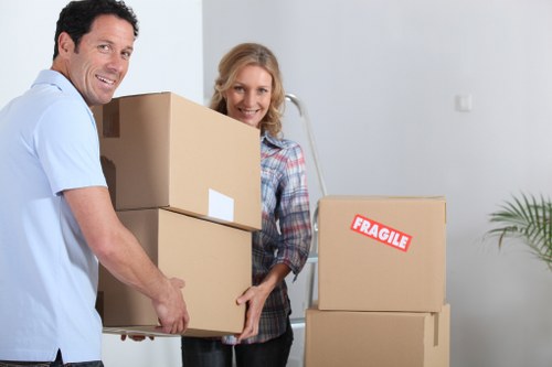 Professional movers transporting boxes and furniture in Perivale